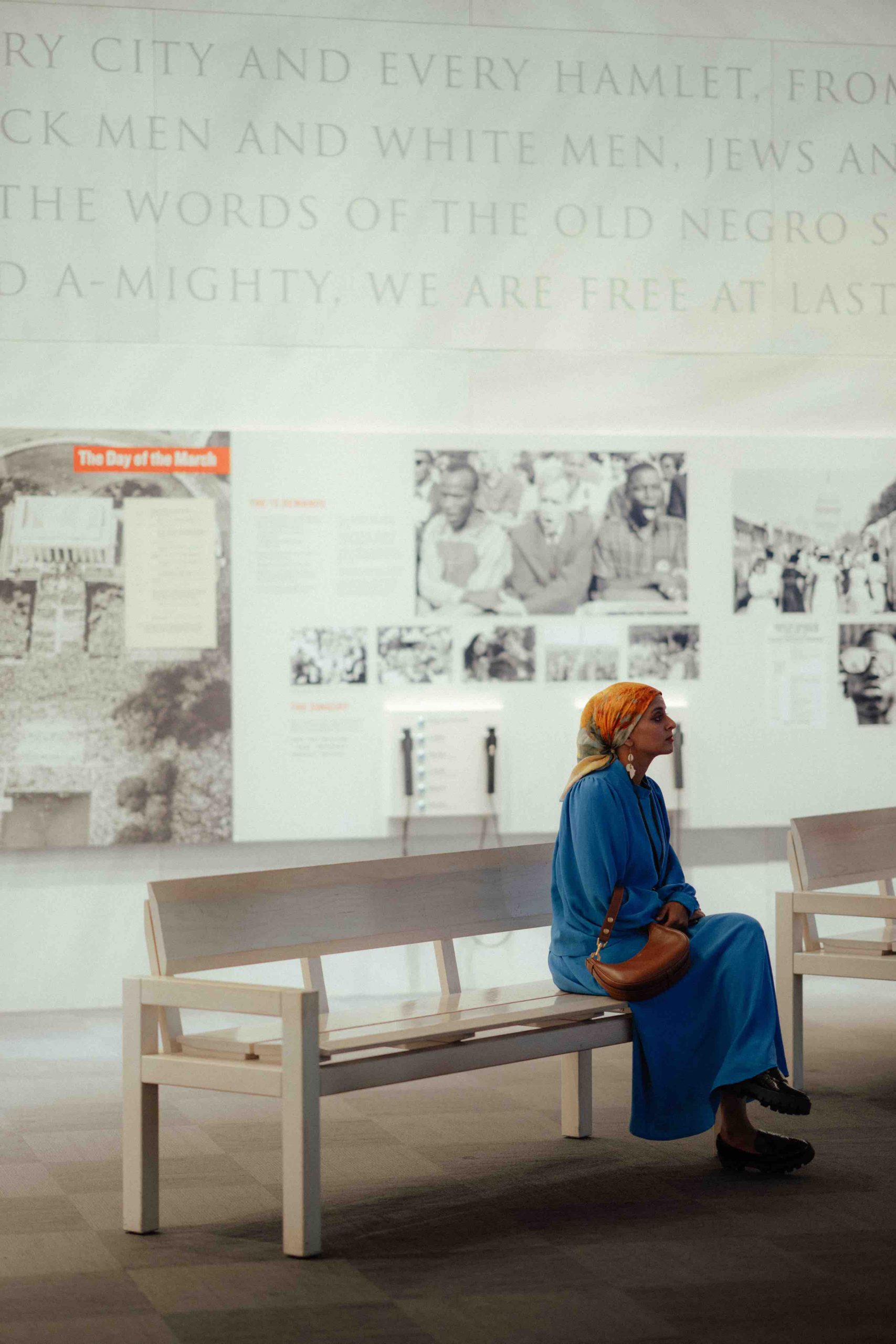 Malikah's Rana Abdelhamid sits contemplatively on a bench in the National Center for Civil and Human Rights