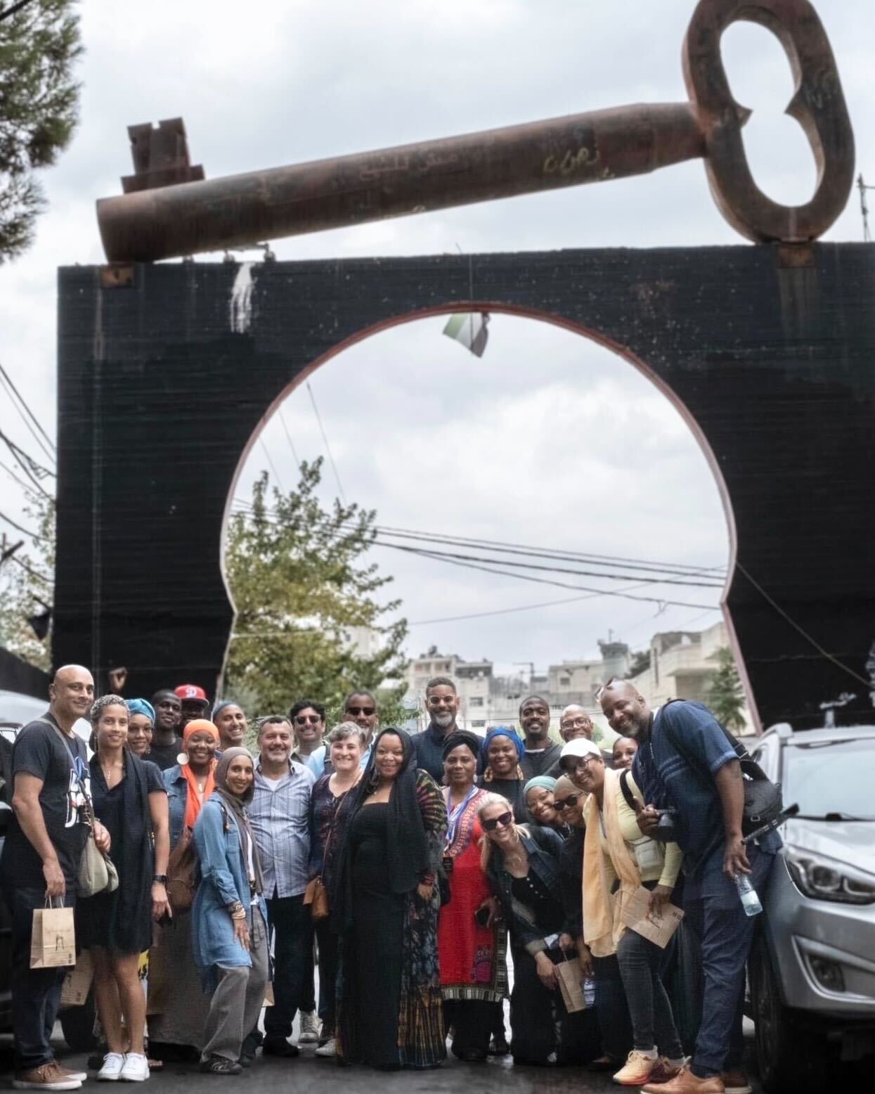 A group photo in front of a huge, iron 